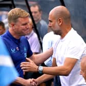 Newcastle United head coach Eddie Howe and Manchester City manager Pep Guardiola shake hands before the game.