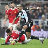 Joelinton of Newcastle United runs with the ball past Jadon Sancho of Manchester United during the Premier League match between Newcastle United and Manchester United at St James' Park on December 27, 2021 in Newcastle upon Tyne, England. (Photo by Ian MacNicol/Getty Images)