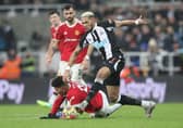 Joelinton of Newcastle United runs with the ball past Jadon Sancho of Manchester United during the Premier League match between Newcastle United and Manchester United at St James' Park on December 27, 2021 in Newcastle upon Tyne, England. (Photo by Ian MacNicol/Getty Images)