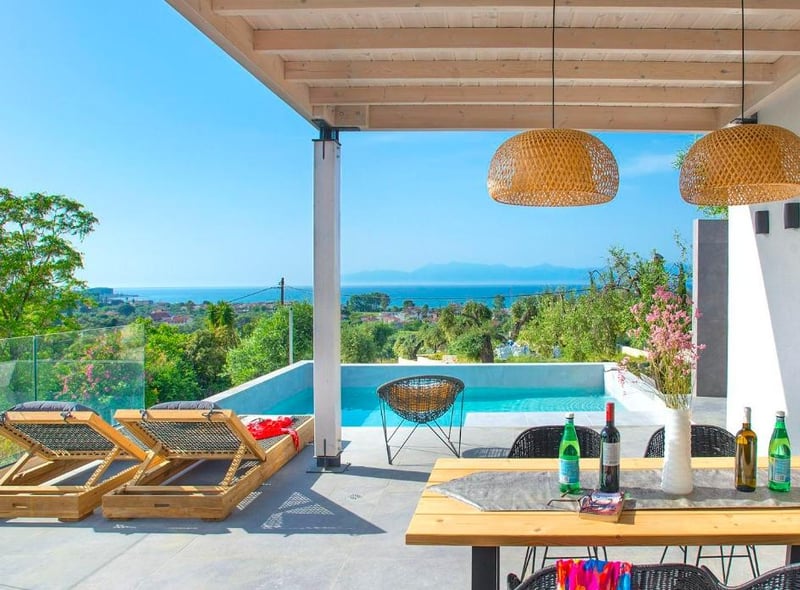A new addition located in a rural-feeling spot amongst olive trees, yet with superb sea views from the pool and terraces and just a 15-minute walk (1.5km) to two coastal towns.
Well thought out, the open living and dining space is bright, fresh and welcoming with doors leading to pool/dining terrace that takes in the gorgeous sea views.
Each bedroom has its own contemporary-styled en-suite shower room with the option to have a double or twin configuration in one of the bedrooms.
This gives families, sharing couples or groups of mixed age the option to choose what suits them best.
In walking distance, the local coastal towns of Acharavi and Roda both have their own beach with plenty of bars, restaurants and shops – or a short drive further there’s a swathe of Blue Flag options.
The price for a one week stay starts from £2152 in August, while a week in May 2023 starts from £826. https://www.vintagetravel.co.uk/villas/villas-in-greece1/filio/