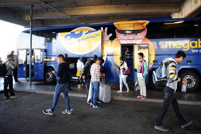 Passengers board a coach of British bus company Megabus (photo: REMY GABALDA/AFP via Getty Images)