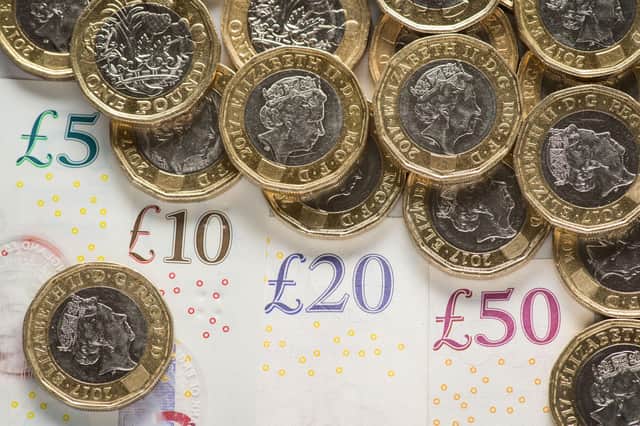 File photo dated 26/01/18 of UK five pound, ten pound, twenty pound and fifty pound notes with one pound coins, as the proportion of children living in families which could not afford essentials fell by a quarter in the six years before the coronavirus pandemic, research suggests.