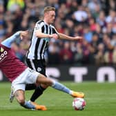 Sean Longstaff of Newcastle United is tackled by Douglas Luiz of Aston Villa during the Premier League match between Aston Villa and Newcastle United at Villa Park on April 15, 2023 in Birmingham, England. (Photo by Shaun Botterill/Getty Images)