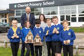 Bellway Sales Manager Chris Lawson, teacher Ashleigh Waite and students from Cheviot Primary School