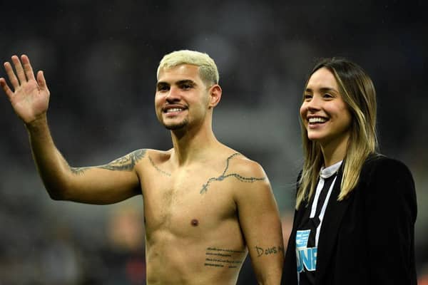 Newcastle United's Brazilian midfielder Bruno Guimaraes and his girlfriend Ana Lidia Martins applauds the fans following the English Premier League football match between Newcastle United and Arsenal at St James' Park in Newcastle-upon-Tyne, north east England on May 16, 2022. (Photo by OLI SCARFF/AFP via Getty Images)
