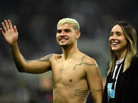 Newcastle United's Brazilian midfielder Bruno Guimaraes and his girlfriend Ana Lidia Martins applauds the fans following the English Premier League football match between Newcastle United and Arsenal at St James' Park in Newcastle-upon-Tyne, north east England on May 16, 2022. (Photo by OLI SCARFF/AFP via Getty Images)