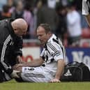 Derek Wright helps Alan Shearer at the Stadium of Light in 2006.