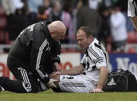 Derek Wright helps Alan Shearer at the Stadium of Light in 2006.