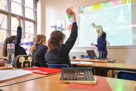 File photo dated 12/09/18 of a teacher and students in a classroom. Poorer pupils are less likely to get into top-performing comprehensive schools than their peers even if there is one in their local area, a study by charity group Sutton Trust has found. Issue date: Thursday January 11, 2024.
