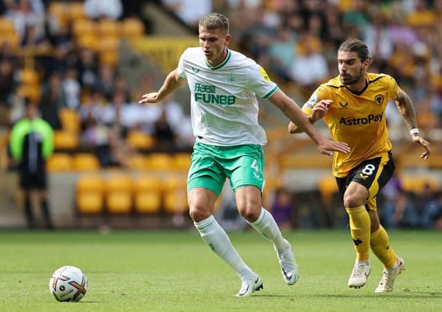 Sven Botman of Newcastle United is put under pressure by Ruben Neves of Wolverhampton Wanderers  during the Premier League match between Wolverhampton Wanderers and Newcastle United at Molineux on August 28, 2022 in Wolverhampton, England. (Photo by David Rogers/Getty Images)