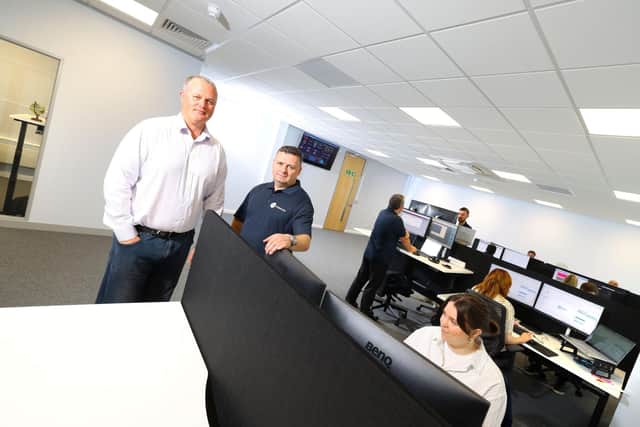 RMT Technology's commercial director Stephen McNickle and managing director Mike Hayes with members of their team in their new purpose-built office. Photo: RMT Technology