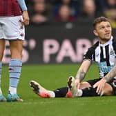 Newcastle full back Kieran Trippier sits down on the turf before leaving the field with an injury during the Premier League match between Newcastle United and Aston Villa at St. James Park on February 13, 2022 in Newcastle upon Tyne, England. (Photo by Stu Forster/Getty Images)