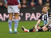 Newcastle full back Kieran Trippier sits down on the turf before leaving the field with an injury during the Premier League match between Newcastle United and Aston Villa at St. James Park on February 13, 2022 in Newcastle upon Tyne, England. (Photo by Stu Forster/Getty Images)
