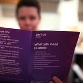 A woman reading a leaflet from the Office for National Statistics (ONS) containing information about The Census 2021, sent to households in England and Wales. Picture date: Monday March 22, 2021.