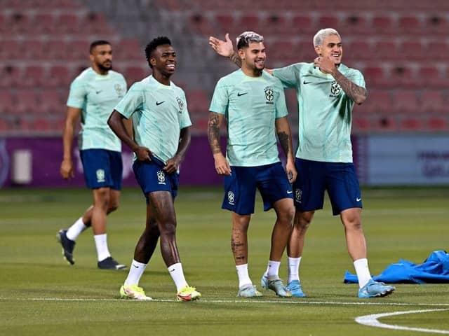 Brazil's forward Vinicius Junior (2nd L), Brazil's midfielder Bruno Guimaraes (C) and Brazil's forward Pedro (R) take part in a training session at Al Arabi SC stadium in Doha on November 23, 2022, on the eve of the Qatar 2022 World Cup football match between Brazil and Serbia. (Photo by NELSON ALMEIDA/AFP via Getty Images)