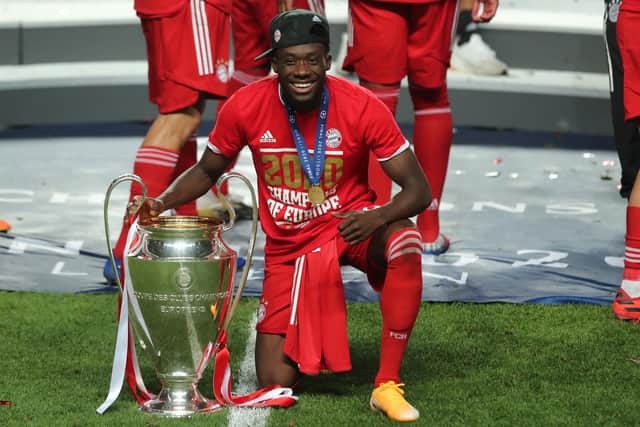 Bayern Munich's Canadian midfielder Alphonso Davies celebrates with the Champions League trophy (Photo by Miguel A. Lopes / POOL / AFP) (Photo by MIGUEL A. LOPES/POOL/AFP via Getty Images)