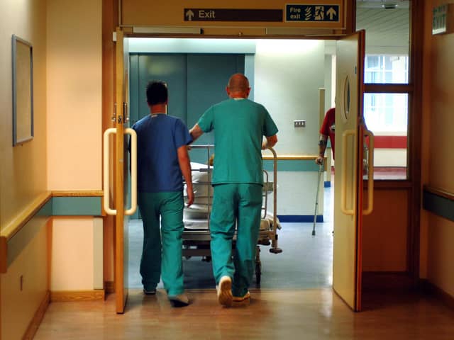 Orderlies push a bed at the Royal Orthopaedic Hospital, Oswestry.