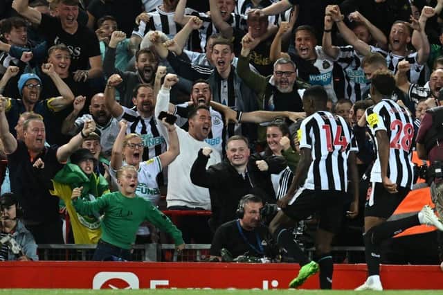 Newcastle United's Swedish striker Alexander Isak (2nd R) celebrates with fans after scoring the opening goal of the English Premier League football match between Liverpool and Newcastle United at Anfield in Liverpool, north west England on August 31, 2022. (Photo by PAUL ELLIS/AFP via Getty Images)