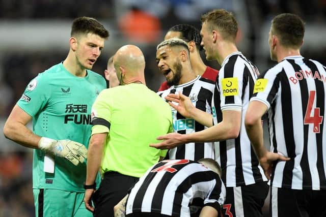 Newcastle United goalkeeper Nick Pope argues with referee Anthony Taylor following his dismissal.