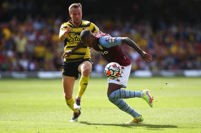WATFORD, ENGLAND - AUGUST 14: Ashley Young of Aston Villa is challenged by Tom Cleverly of Watford during the Premier League match between Watford and Aston Villa at Vicarage Road on August 14, 2021 in Watford, England. (Photo by Charlie Crowhurst/Getty Images)