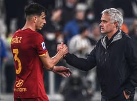 Jose Mourinho congratulates Roma's Brazilian defender Roger Ibanez. (Photo by Marco BERTORELLO / AFP) (Photo by MARCO BERTORELLO/AFP via Getty Images)