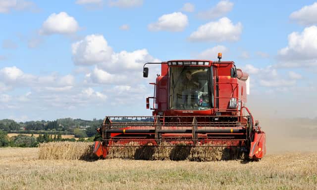 Stock. A combine harvester works in a wheat field, near Mountnessing, in Essex. PRESS ASSOCIATION Photo. Picture date: Friday August 15, 2008. Photo credit should read: Ian Nicholson/PA