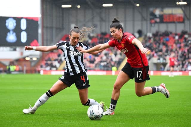 Lucia Garcia of Manchester United is challenged by Amber-Keegan Stobbs of Newcastle United during the Adobe Women's FA Cup Fourth Round match. (Photo by Ben Roberts Photo/Getty Images)