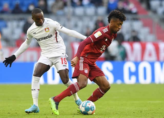 Bayern Munich's French midfielder Kingsley Coman (R) and Leverkusen's French striker Moussa Diaby vie for the ball.