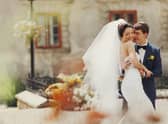 Groom holds bride's waist tenderly at a wedding in Spain